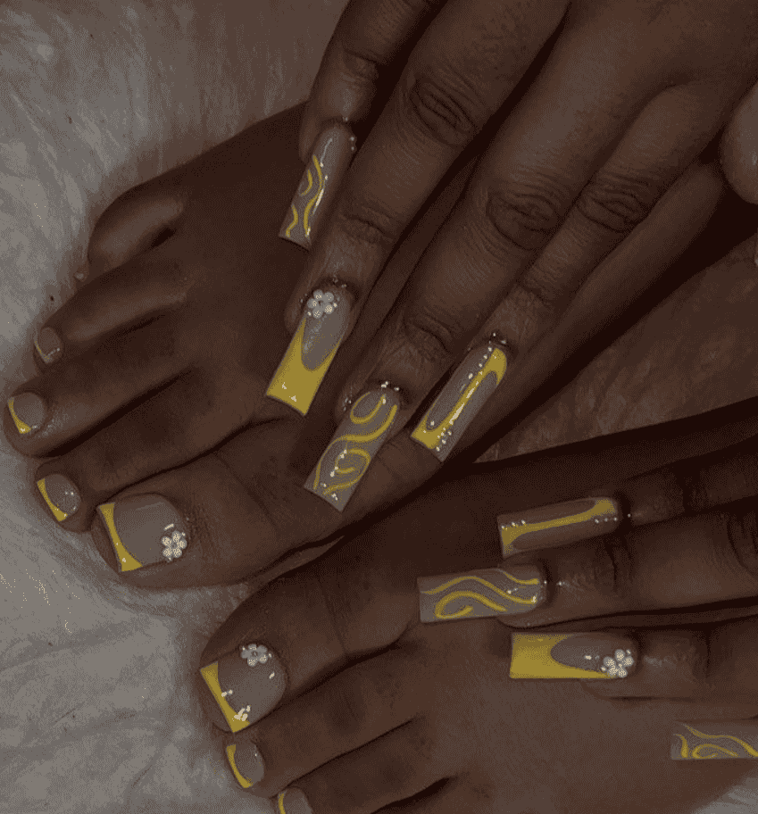 Yellow mani pedi with lines